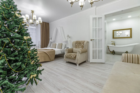 Nordic, cozy living room interior with a Christmas tree, white tones, coffee table, and sofa.の写真素材