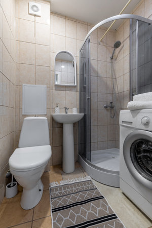 Compact Modern Bathroom with Washerの写真素材