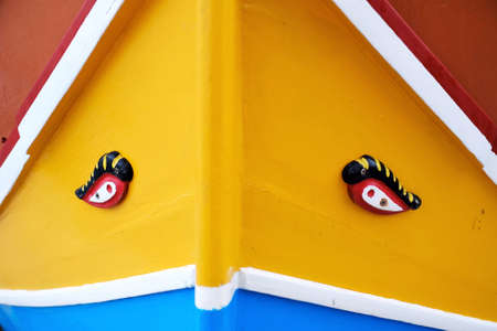 closeup of colorful traditional boat called 'luzzu' in Marsaxlokk, Malta, with eyes painted to protect fishermen at seaの写真素材