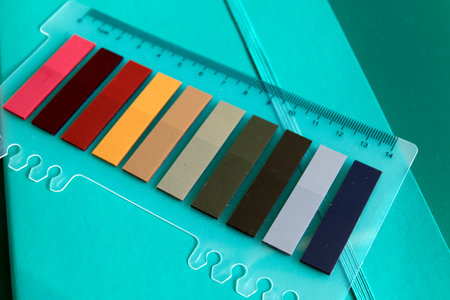 set of colorful sticky notes or paper tags and ruler on mint green notebook - selective focusの写真素材