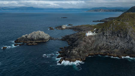 Kraakenes lighthouse on rocky coast, in Vaagsoy, Norway 2018の写真素材