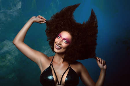 Girl in studio with an African hairstyleの写真素材