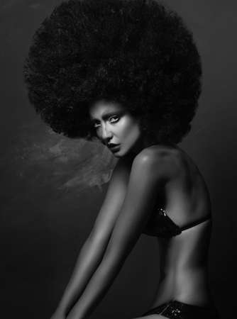 Girl in studio with an African hairstyleの写真素材