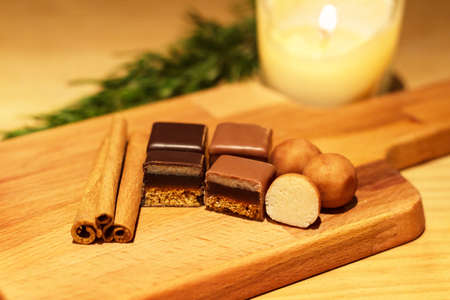 Christmas sweets gingerbread, marzipan and cinnamon on wooden trayの写真素材