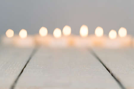 De-focused candles on white rustic woodの写真素材