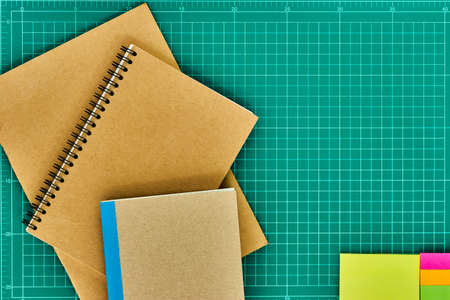Recycled paper notebook, School supplies on paper cutting board.の写真素材