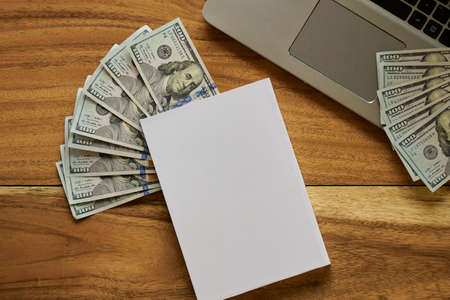 Book with money and Laptop flat layoutの写真素材