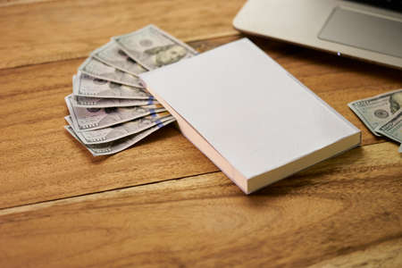 Book with money and Laptop flat layoutの写真素材