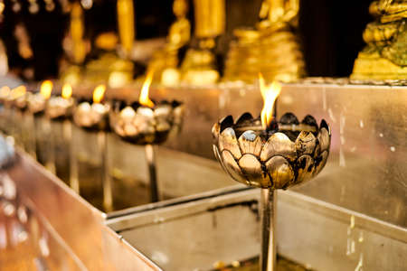 buddhist candles in Thai tempel selective focusの写真素材