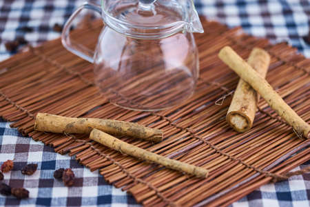 Burdock root with empty tea pot and cup.の写真素材