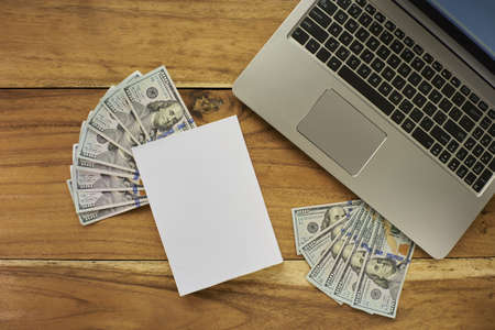 Book with money and Laptop flat layoutの写真素材