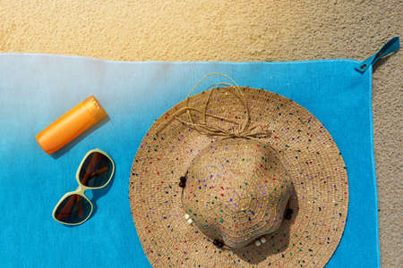 Top view of sandy beach with summer accessories and copy space around products. Blank mock up for advertising or packaging.の写真素材