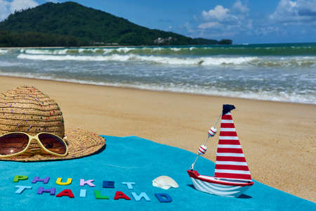 Top view of sandy beach with summer accessories with PHUKET THAILAND words.の写真素材