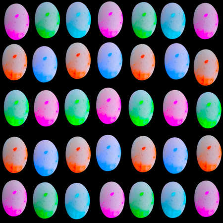 A seamless background design with colorful small stones on black backgroundの写真素材