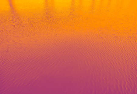 A 3D illustration of a bright orange and pink abstract water backgroundの写真素材