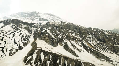 Snow covered mountains in summer with fog