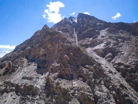 Blue sky with clouds over sand mountainの写真素材