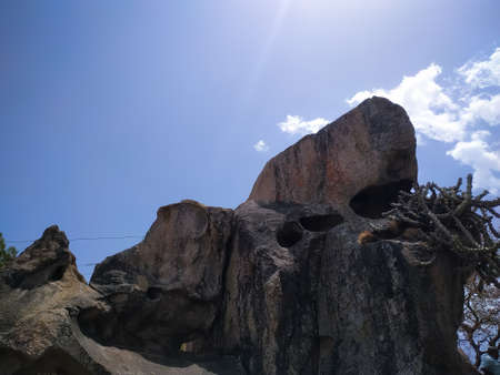 A rock in the mountains with blue sky and cloudの写真素材