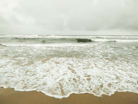 Beautiful sea waves on the sand beachの写真素材