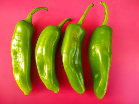 Fresh green peppers isolated on pink backgroundの写真素材