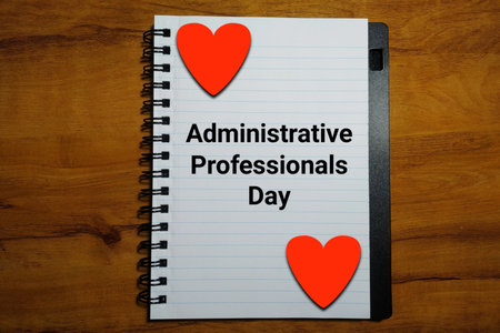 Administrative Professionals Day on notebook with heart on wood backgroundの写真素材