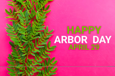 Happy Arbor Day April 29 with green leaf on pink background.の写真素材