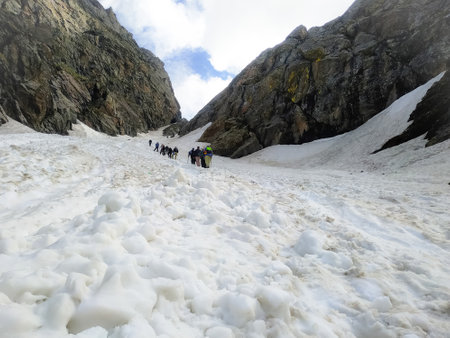 Climbers walking on the snow-covered slope of a mountain