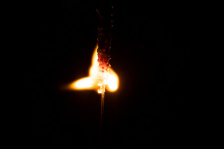 Burning sparkler on a black background. Close-up of a burning sparkler.