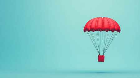 Parachute with red box on blue background. Copy space.の素材