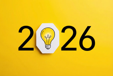 2026 new year on a yellow background with a lightbulbの素材