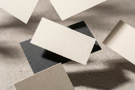 Close-up of business cards on grey textured background. Mockup for branding identity.の素材