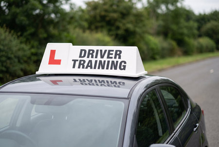 A sign reading Driver Training on the side of a car on a country roadの素材
