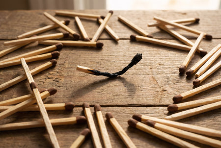 Wooden matchsticks on a wooden background. Selective focus.の素材