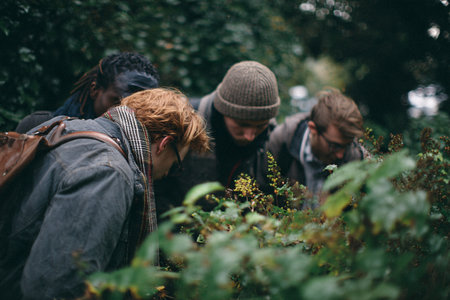 Group of friends spending time together in the forest, having fun and talkingの素材