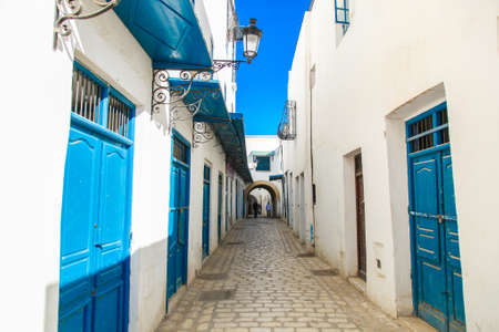 Tunis streets with traditional white and black painted buildings and architecture