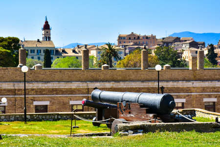Old canons in the venetian fortress with the new Corfu Town in the background.のeditorial素材