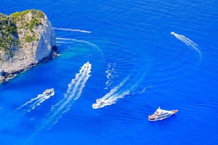 Boats anchored at sea in Greece near Zakynthos Island, Navagio Bay.Shipwreck daily tours.の写真素材