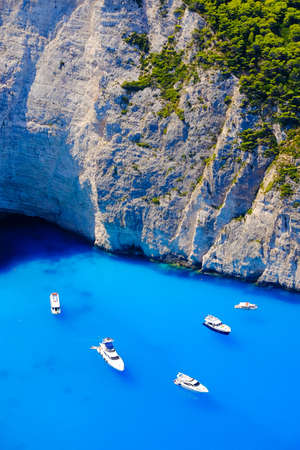 Boats anchored at sea in Greece near Zakynthos Island, Navagio Bay