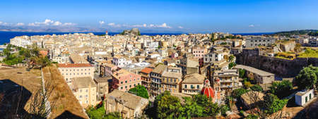 Corfu town panorama over the old city. Venetian fortress in background and old clock tower, city...