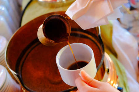 Making traditional greek / turkish black coffee on sandの写真素材