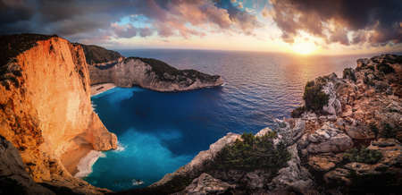 Sunset at Navagio Bay Zakynthos Greece. Panoramic view over the sea with famous shipwreck in the background. Artistic filter applied.の写真素材