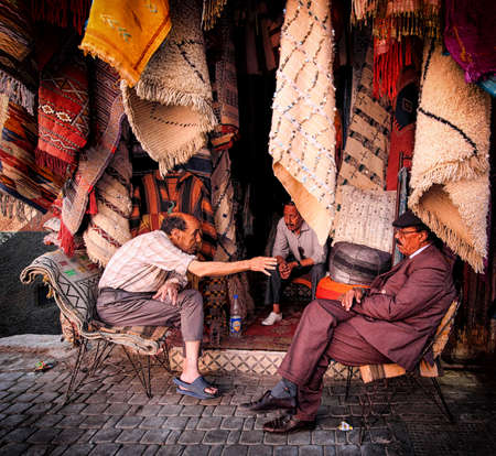 MARRAKECH, MOROCCO, JUNE 2016: Street vendors discussing in front of their traditional shops in the old medinaのeditorial素材