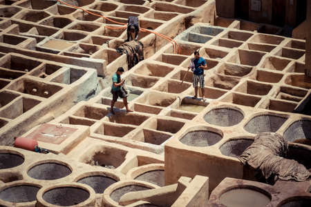 FEZ, MOROCCO, JUNE 2016: workers in the traditional leather colouring facility