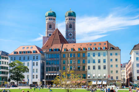 Munich, Germany, Sept. 2015: office building in the old city center. The biggest catholic Cathedral visibile in the back.のeditorial素材