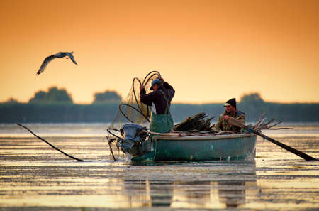 Danube Delta, Romania, June 2017: fishermans checking nests at sunrise in Danube Deltaのeditorial素材