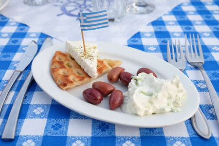 Traditional Greek Appetizer with Olives, Tzatziki, cheese and breadの写真素材