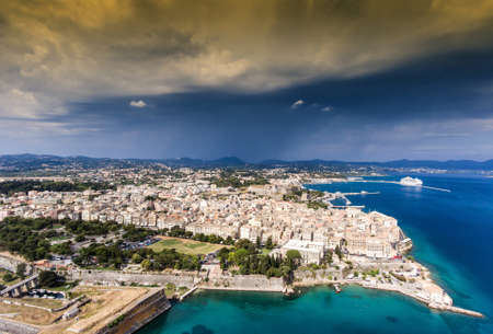 Corfu old city, aerial view, with venetian fortress on the left and the old fortress visibile in the back. Dramatic weather.のeditorial素材