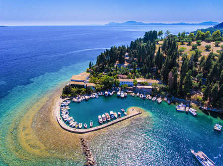 Kouloura old fishing village and beach. Corfu (Kerkyra) Island, Greece, Europe. Fishing boats and clear blue waters.の写真素材