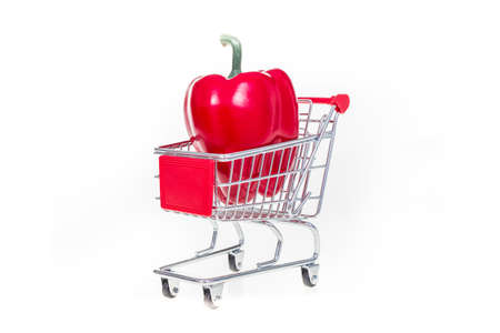 Shopping cart with red bell pepper isolated on white backgroundの写真素材