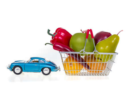 Shopping basket full with vegetables and fruits   isolated on white backgroundの写真素材